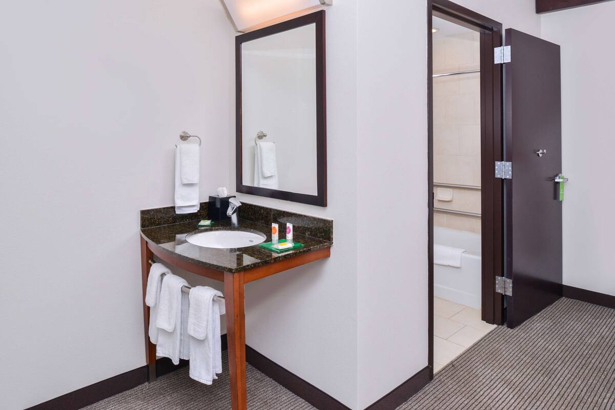 combined shower/bathtub, designer toiletries, hair dryer, towels