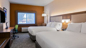 A hotel room with two beds, a desk, a chair, a TV, and a window with a view.