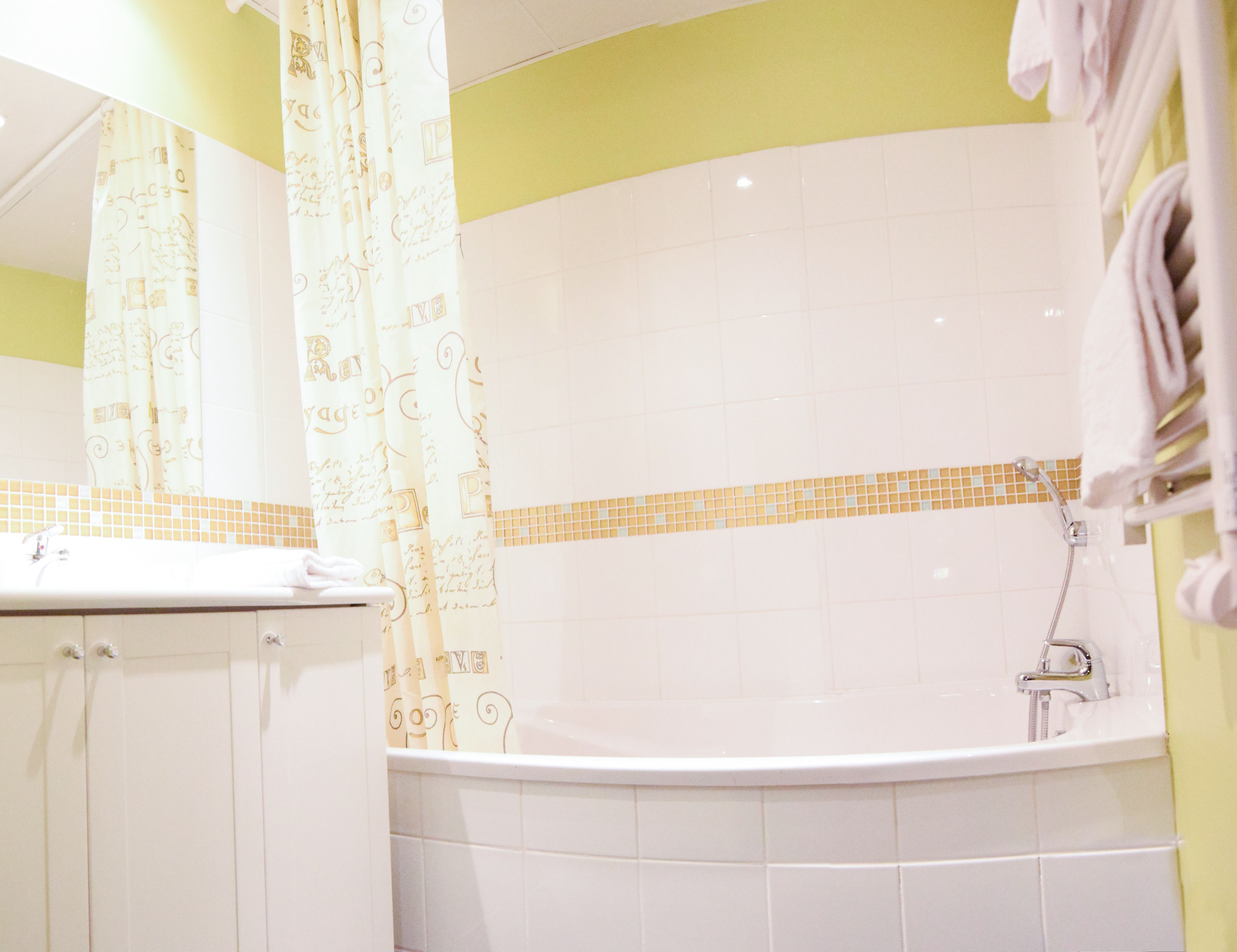 A bathroom with a bathtub, a shower, and a sink.