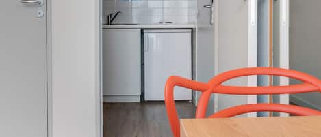 A modern kitchen with white cabinets, a built-in oven, and a sink.