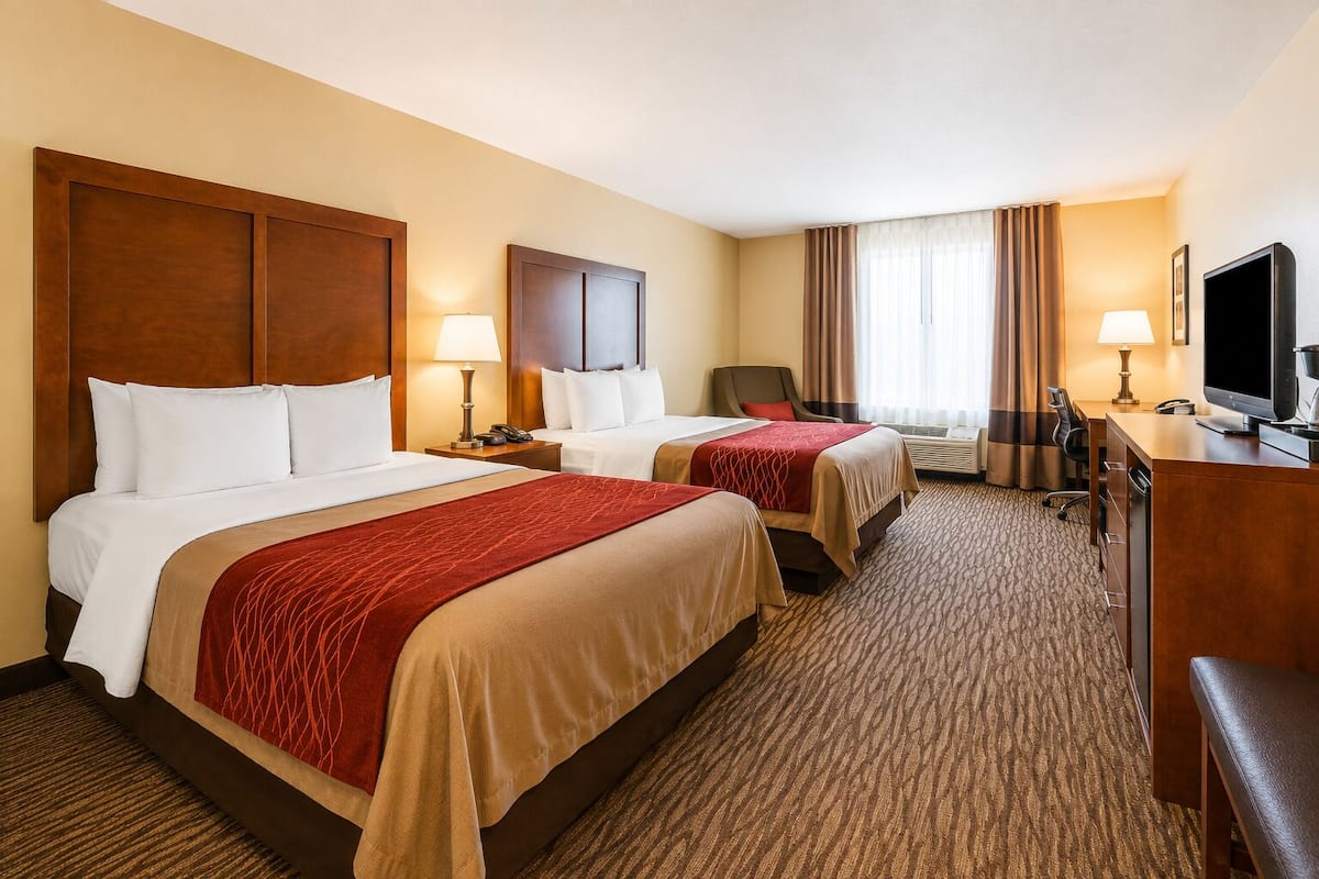 Premium bedding, desk, laptop workspace, blackout drapes