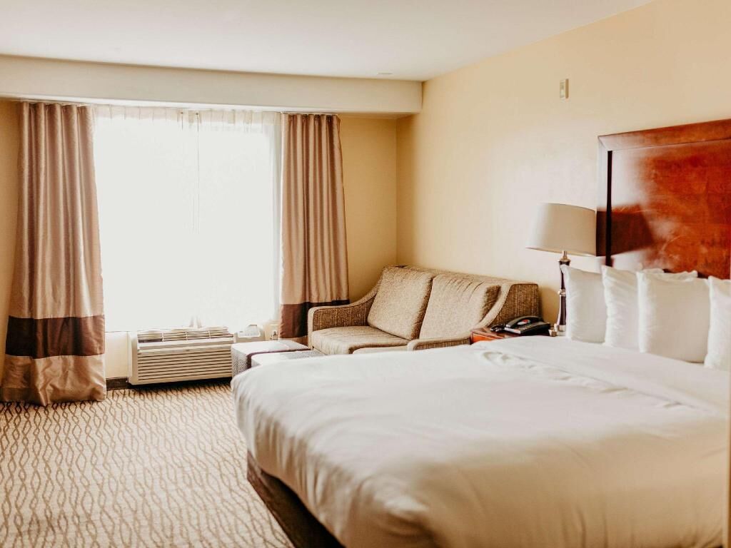 Premium bedding, desk, laptop workspace, blackout drapes
