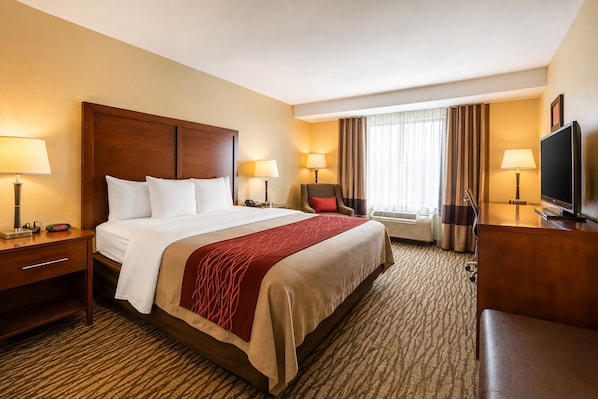 Premium bedding, desk, laptop workspace, blackout drapes