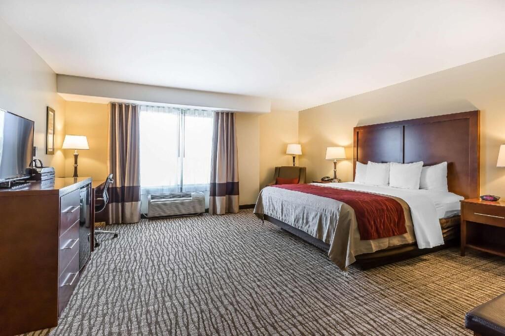 Premium bedding, desk, laptop workspace, blackout drapes