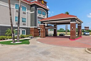 Stunning hotel entrance with a covered walkway and beautifully landscaped surroundings.