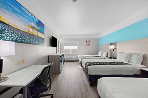 Relax in a spacious room with a large bed, a smaller bed, a desk, and a flat-screen TV.