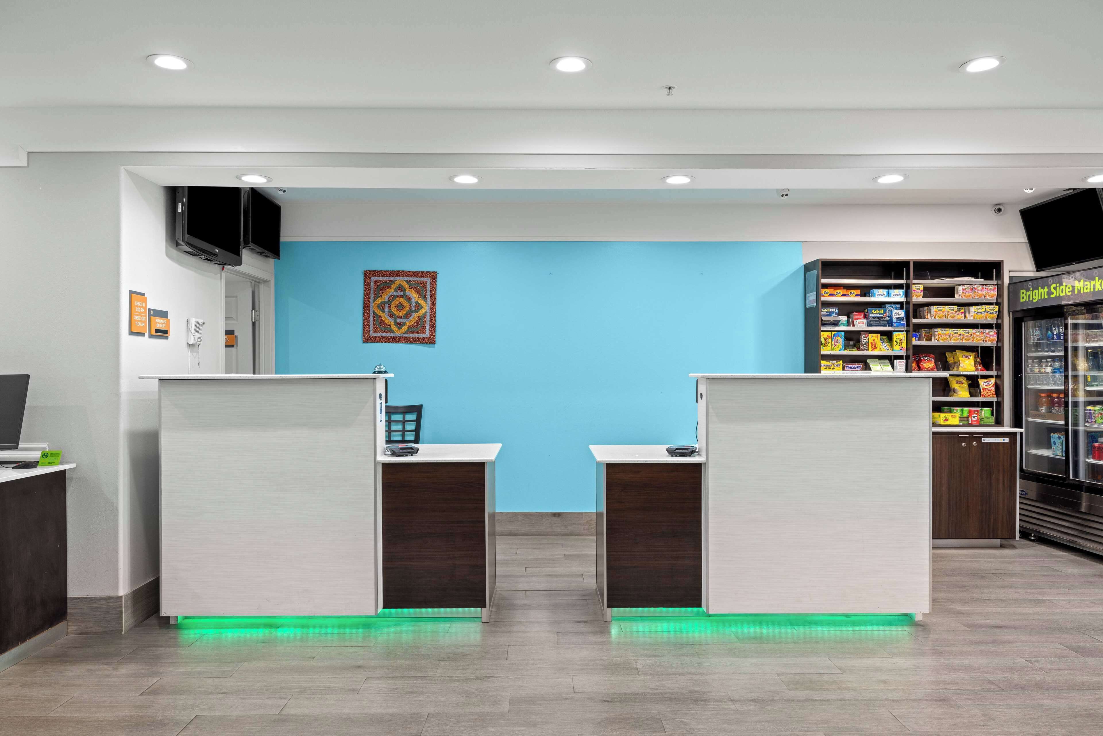 A reception area with two counters, a blue wall, and a Bright Side Market display.