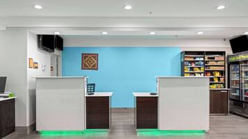 A reception area with two counters, a blue wall, and a Bright Side Market display.