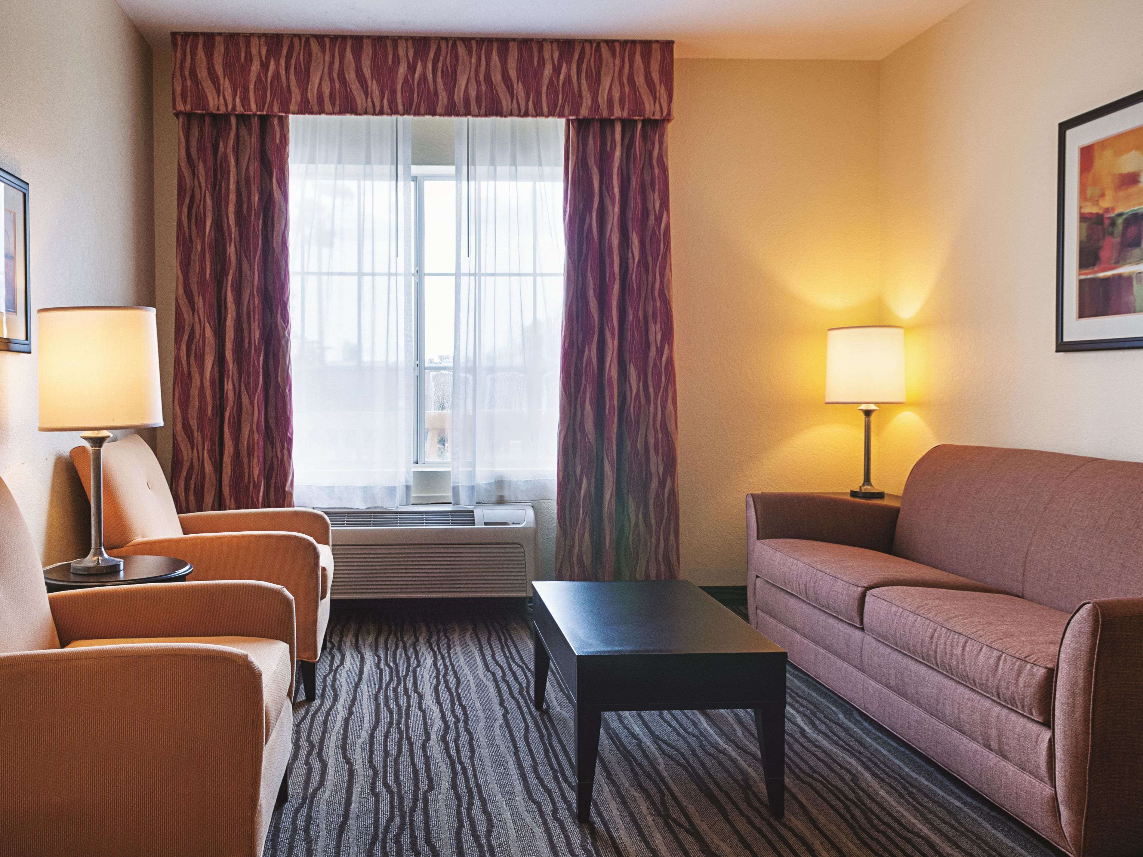 deluxe suite, 1 king bed, non smoking | desk, blackout curtains, iron/ironing board, free cots/infant beds