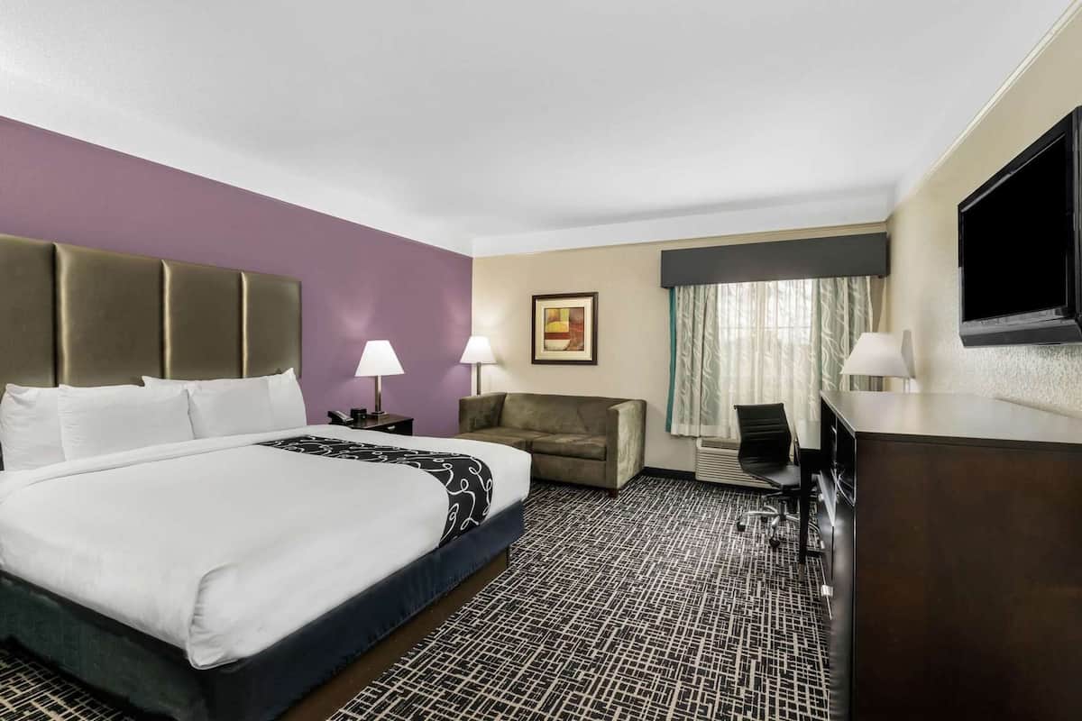 Premium bedding, desk, laptop workspace, blackout drapes
