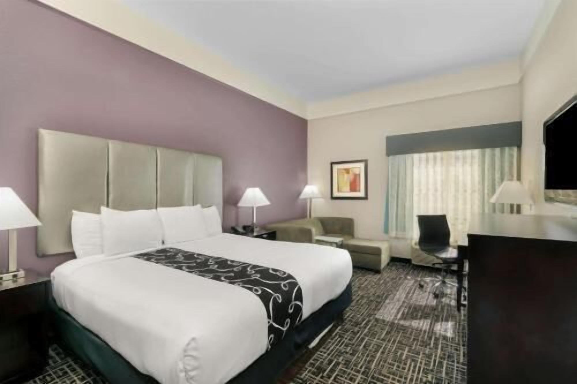 Premium bedding, desk, laptop workspace, blackout drapes