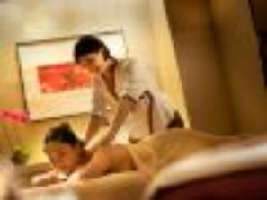 A room with a bed, a person lying on the bed, and another person standing beside the bed. - Crowne Plaza Beijing Zhongguancun by IHG (Beijing)