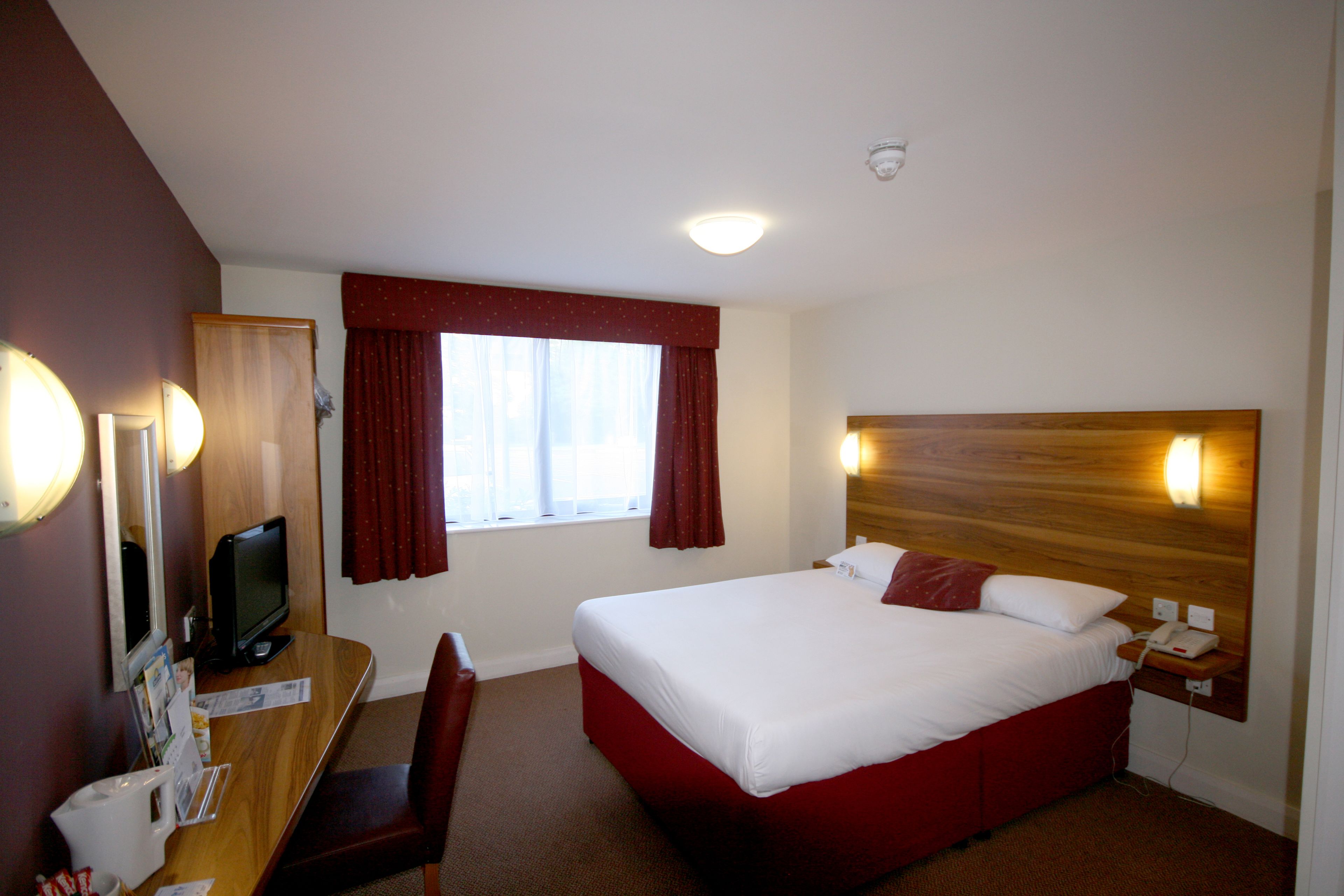 hypo-allergenic bedding, desk, laptop workspace, blackout curtains