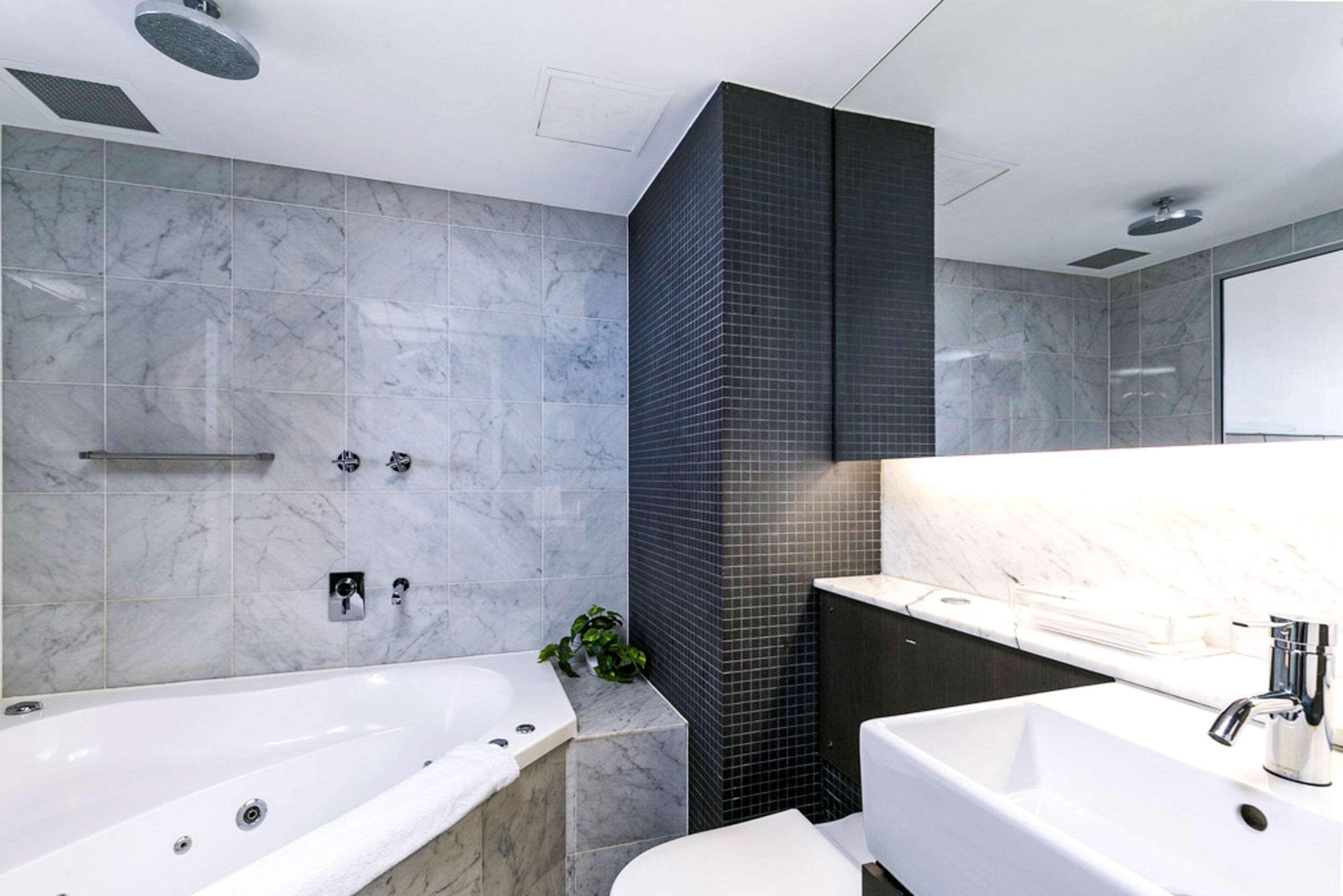 spa suite | bathroom | combined shower/bathtub, designer toiletries, hair dryer, dressing gowns