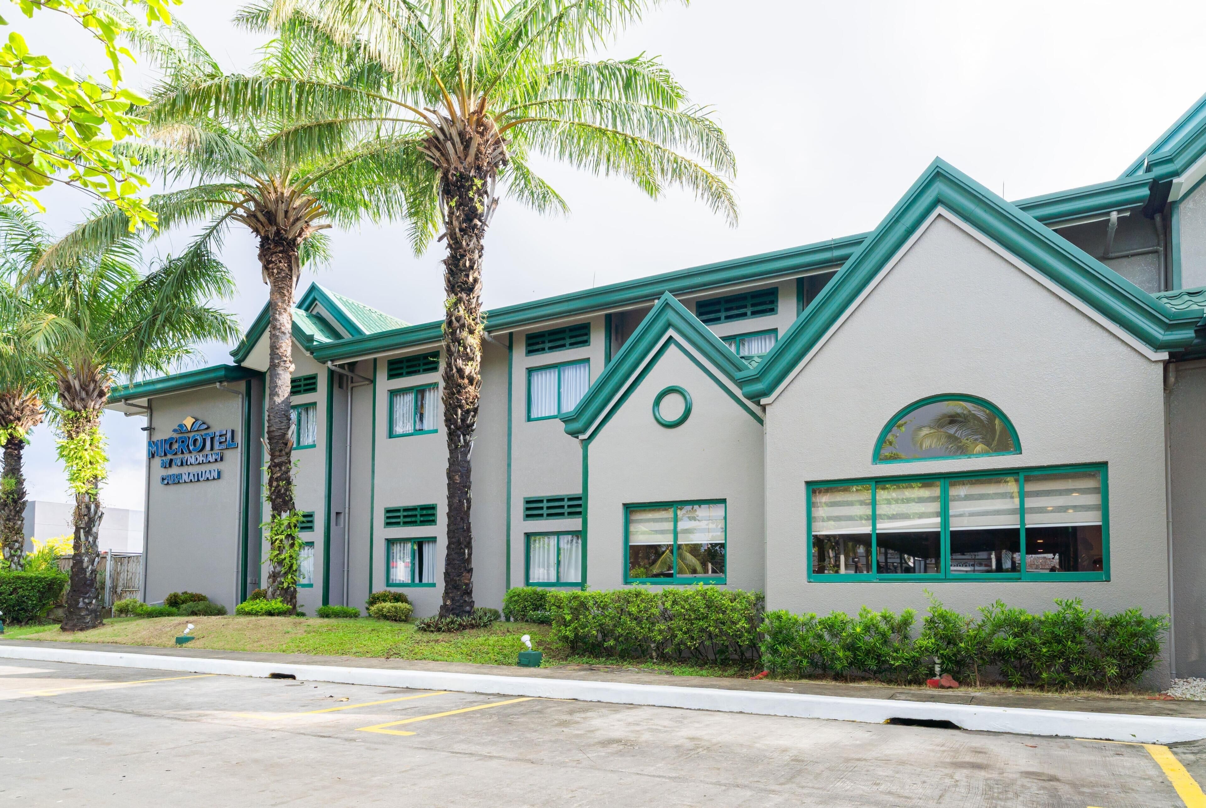 A building with a sign reading 'MICROHOTEL' and a green roof.