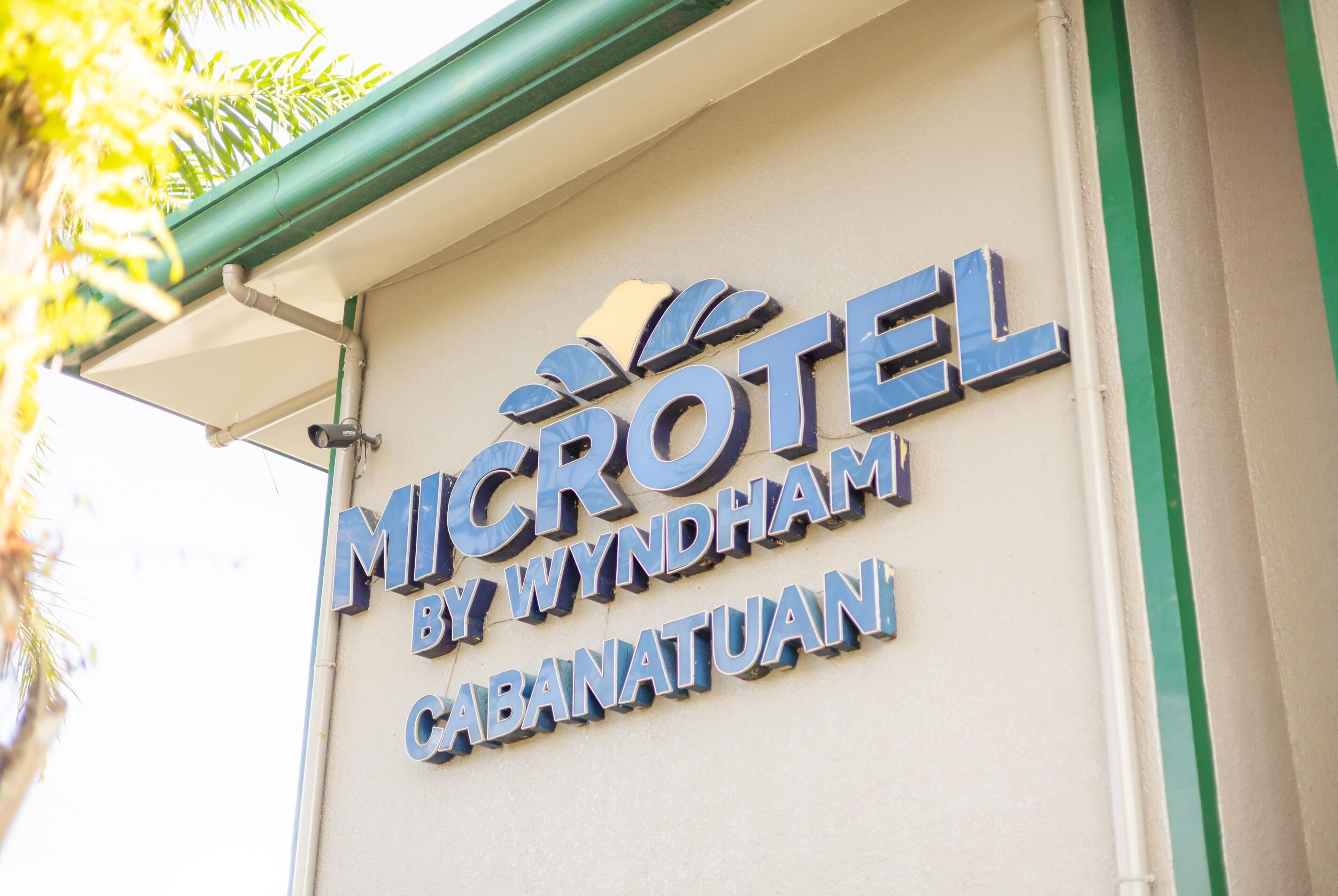A hotel sign with the name 'MICROTEL BY WYNDHAM CABANATUAN'.
