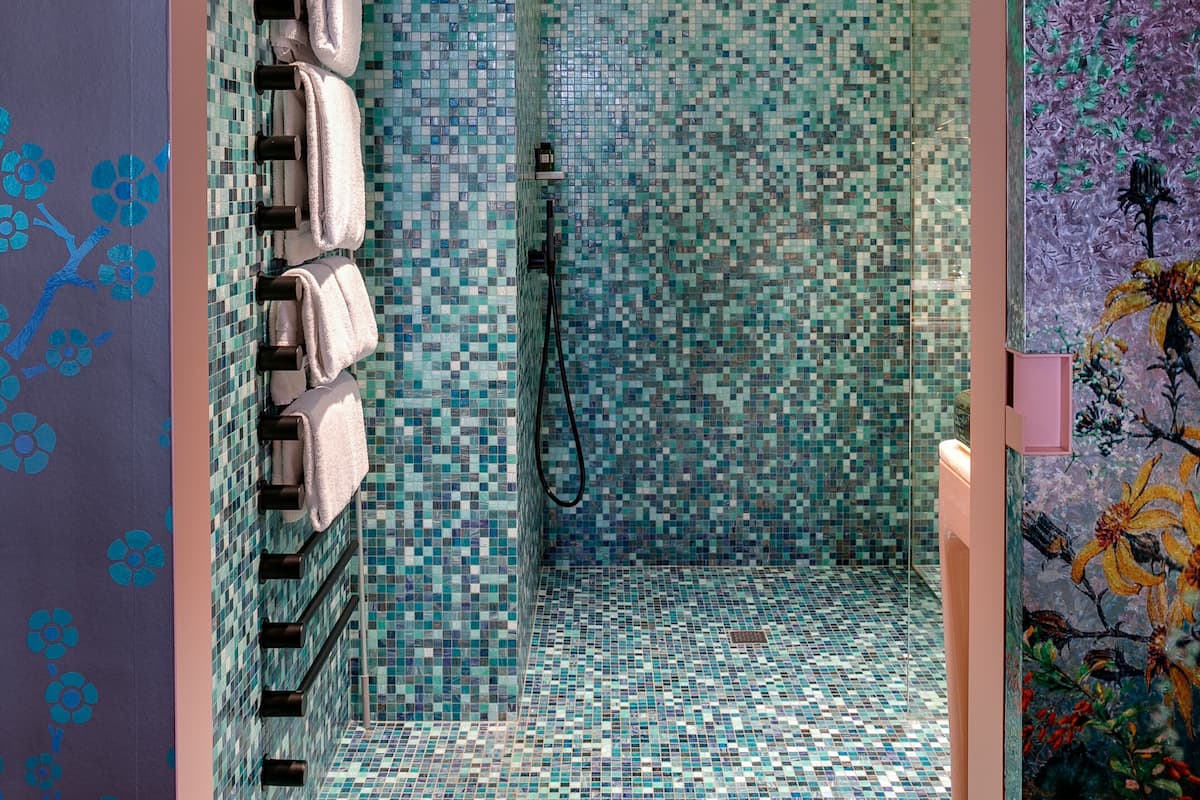 deluxe double room | bathroom | combined shower/bathtub, designer toiletries, hair dryer, bathrobes