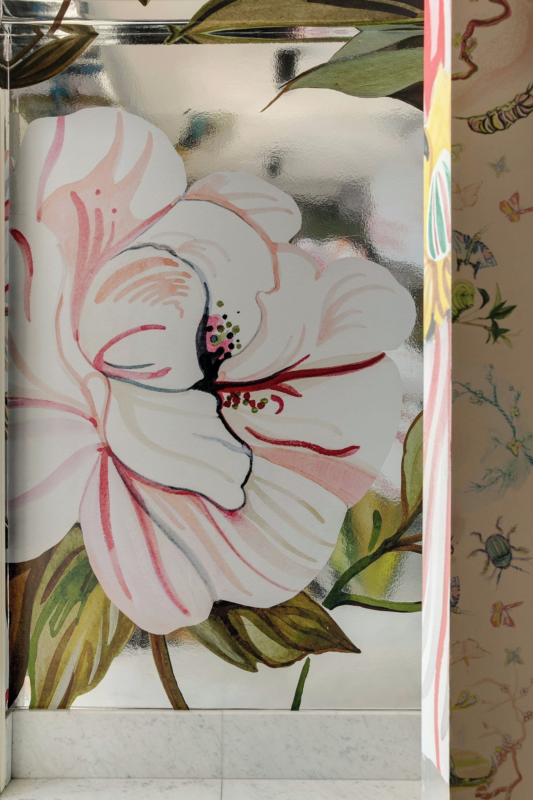 A bathroom with a floral mural on the wall.