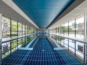 A long indoor swimming pool with clear signage indicating shallow water and no diving. - Mercure Kooindah Waters Central Coast (Wyong)