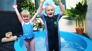 Two children playing in a small indoor pool with a window and plants in the background. - Arista of Rotorua (Rotorua)