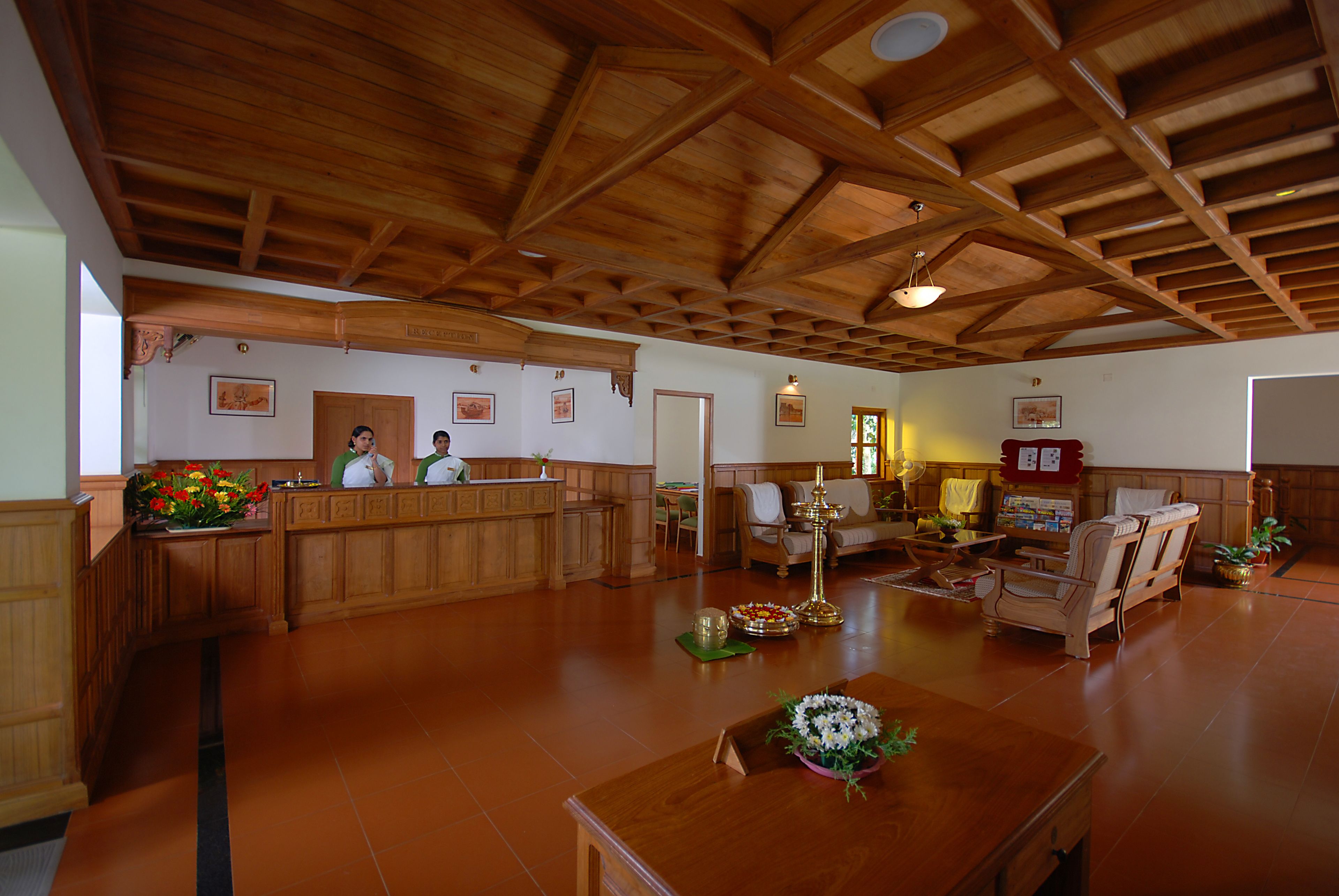 A spacious lobby with a wooden ceiling and a reception desk.