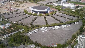 An aerial view of a stadium surrounded by parking lots and buildings.