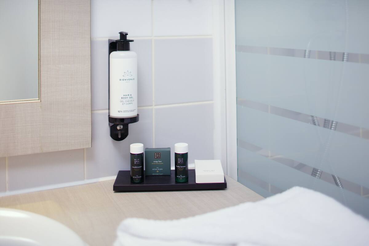 rainfall showerhead, eco-friendly toiletries, hair dryer, towels