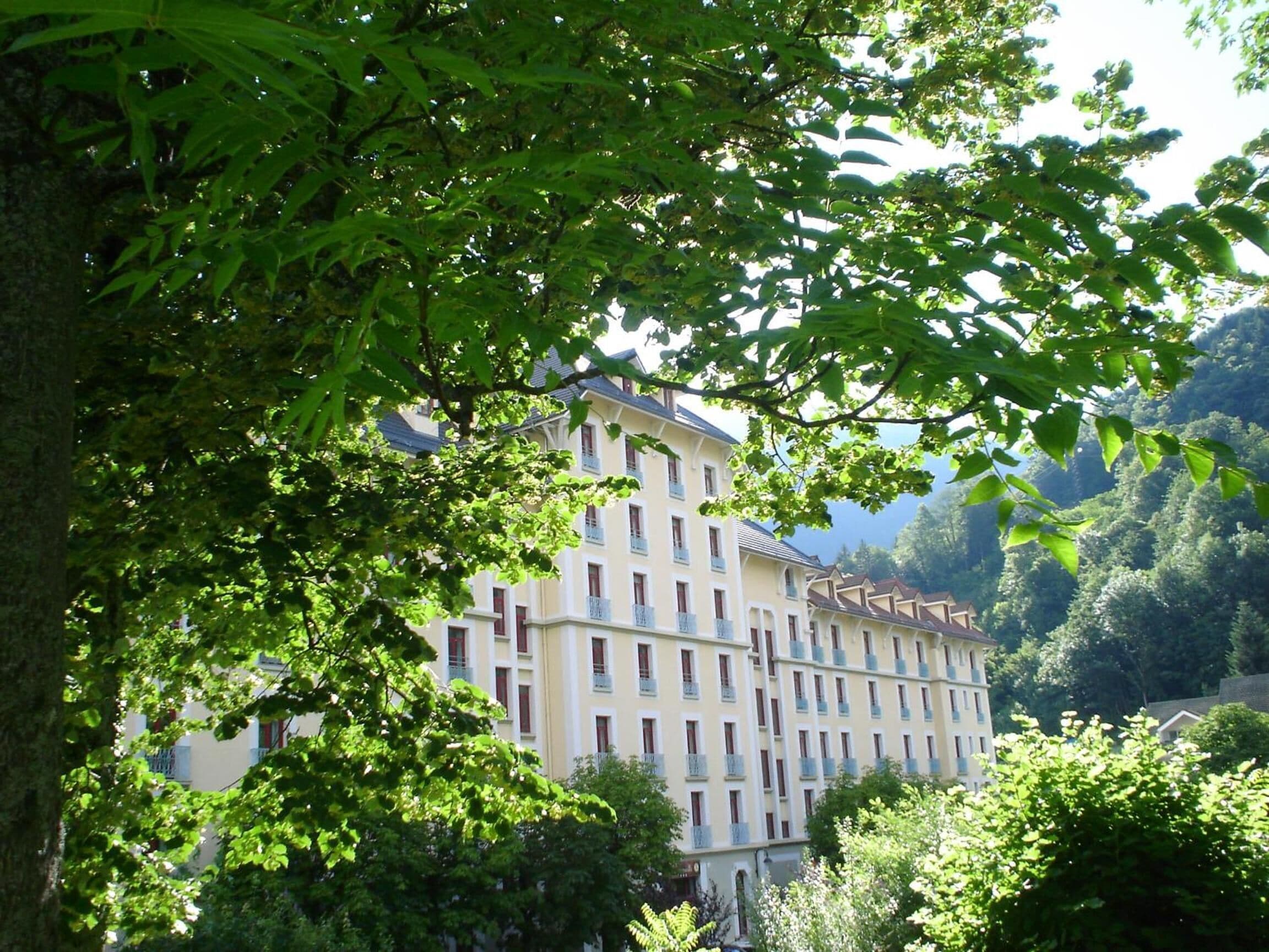 A multi-story hotel with a traditional European architectural style, featuring a symmetrical facade with evenly spaced windows and balconies.