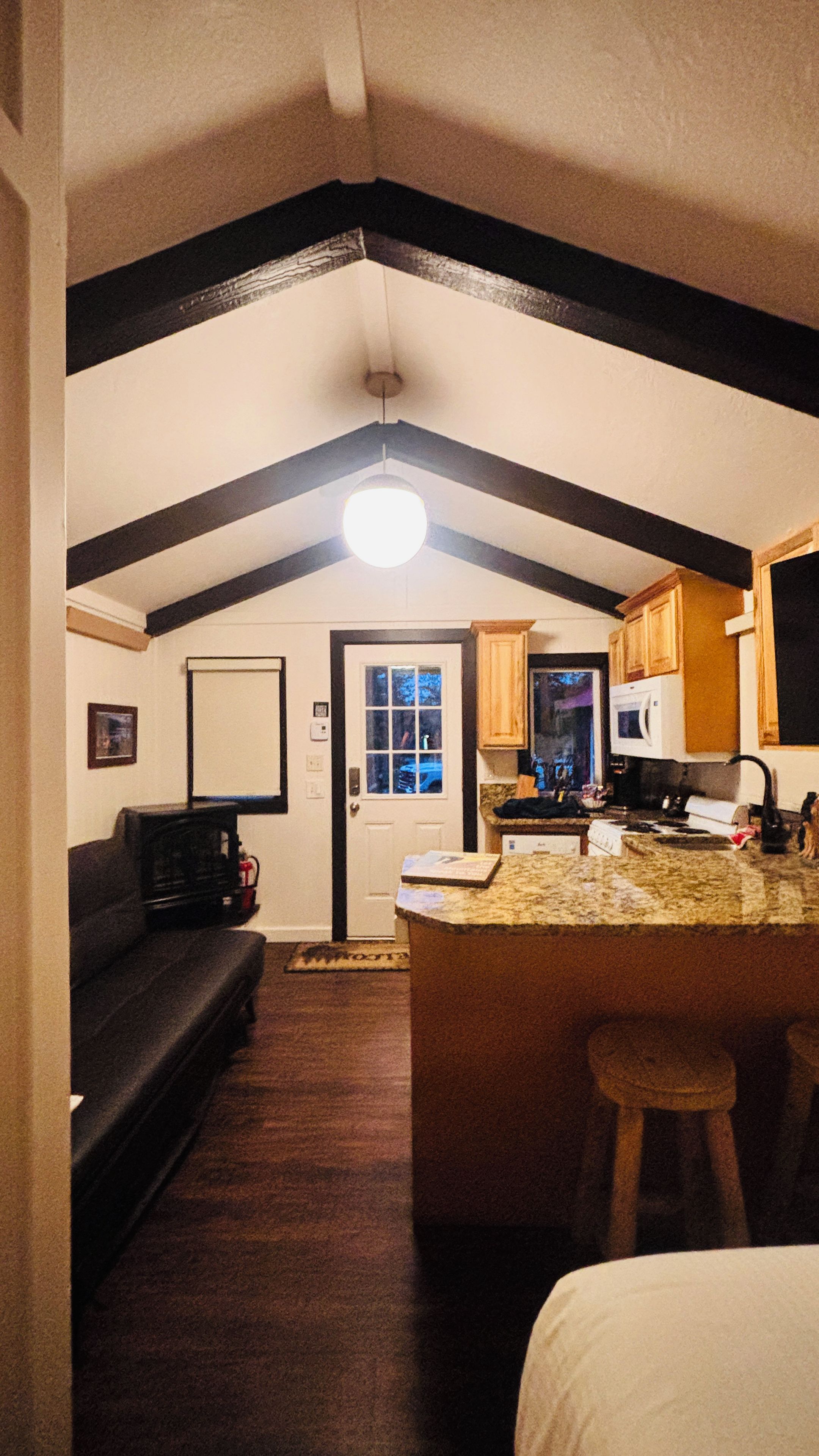 A compact living space with a kitchen area, a dining area, and a seating area.