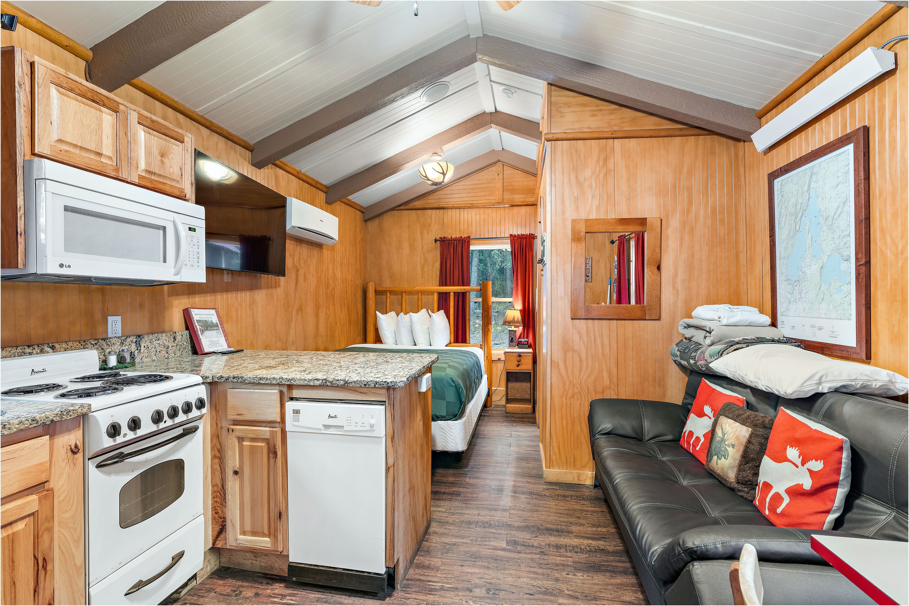 A compact RV kitchen with a stove, microwave, and dishwasher.