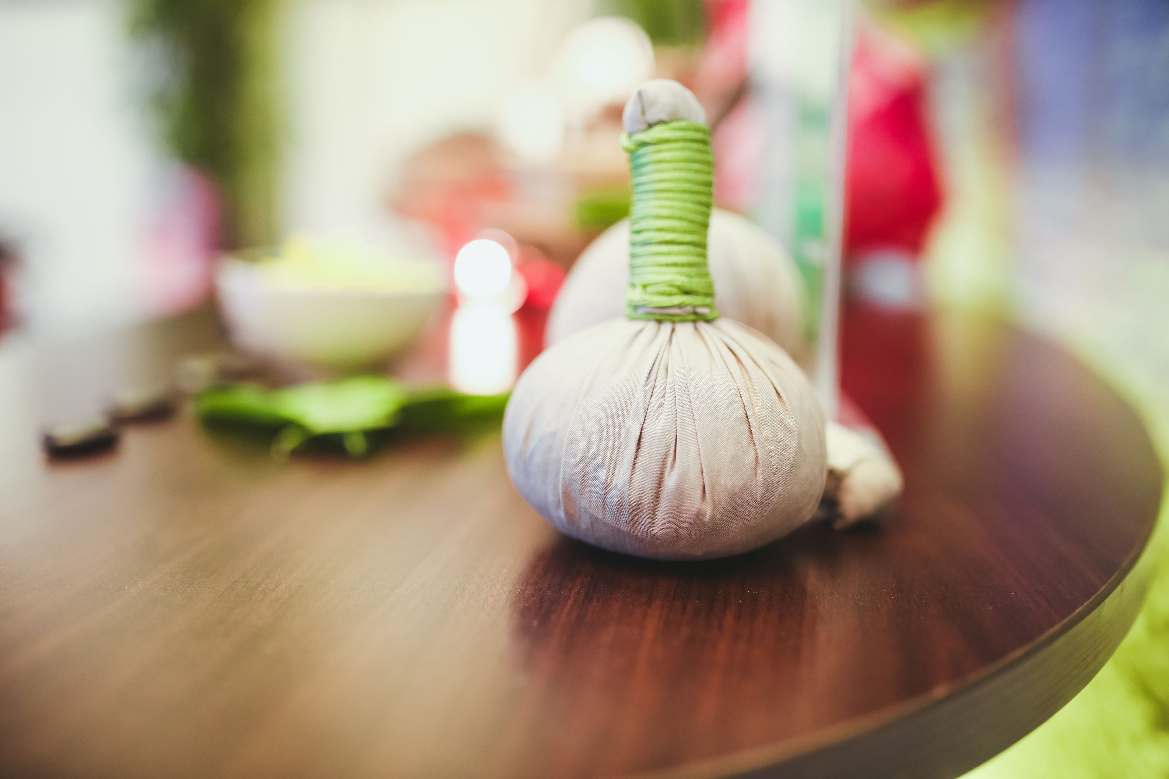 A close-up of a garlic bulb on a wooden surface.