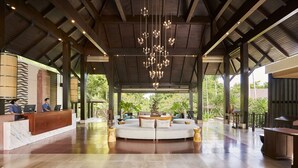A spacious lobby with a reception desk, seating area, and a large chandelier. - Sea Sand Sun Resort and Villas (Sattahip)