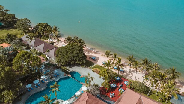 An aerial view of a resort with a swimming pool, beach, and palm trees. - Sea Sand Sun Resort and Villas (Sattahip)