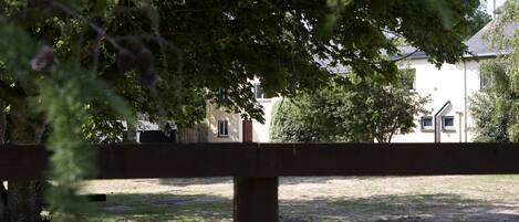 A fenced area with a building in the background.