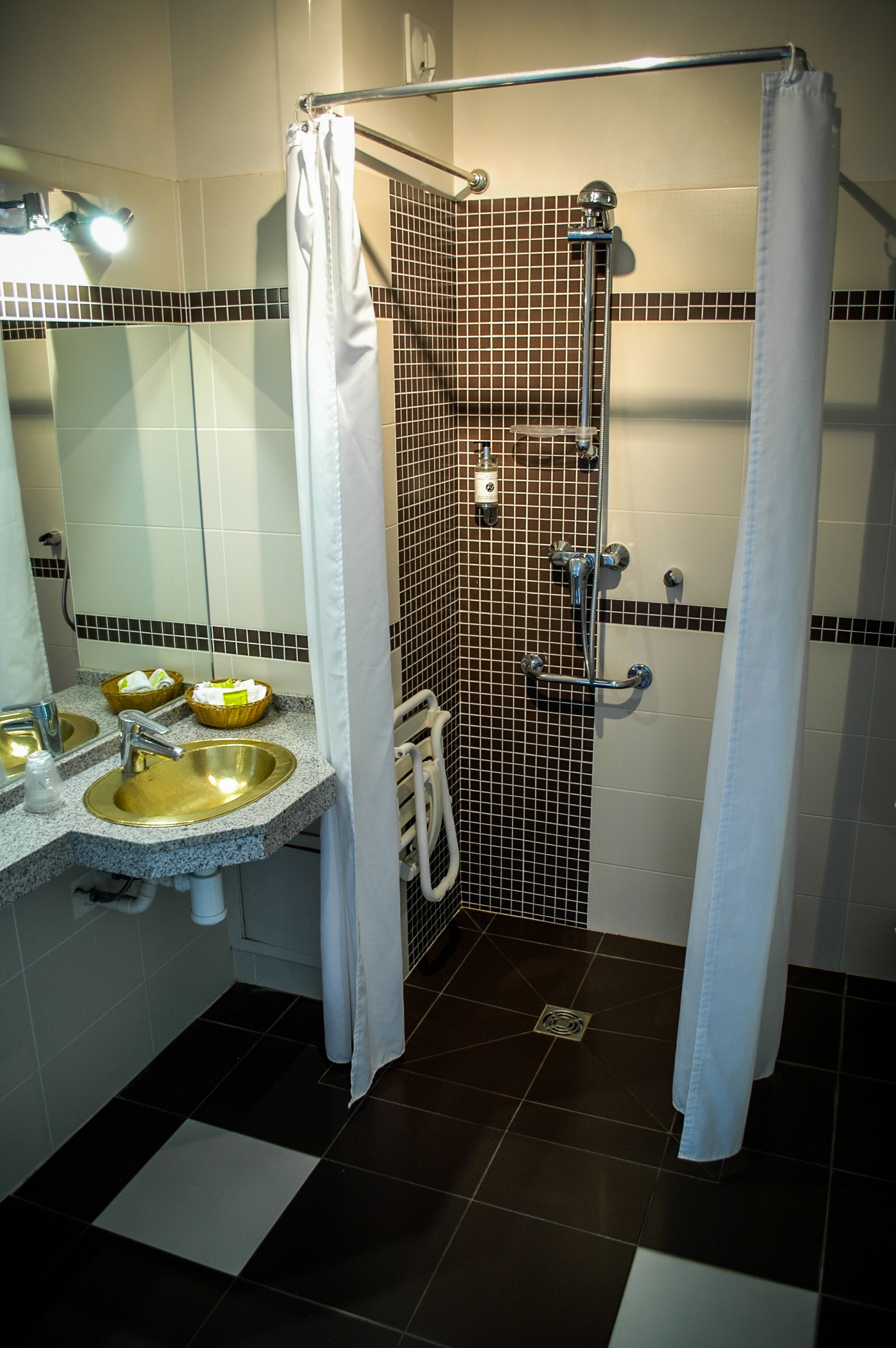 Une salle de bain avec une douche, un lavabo et un miroir.