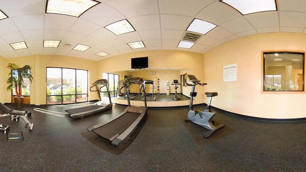 A fitness center with treadmills, elliptical machines, and a stationary bike.