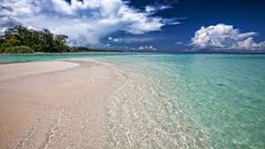 A beach with clear turquoise water and a sandy shore. - Goldfinch Hotel Mangalore (Mangaluru)