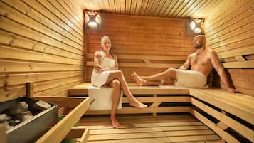 A sauna with wooden benches and benches, a bench with a towel, and a bench with a towel.