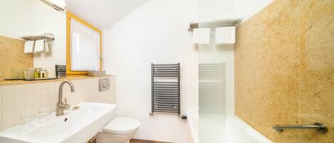 A bathroom with a sink, toilet, and shower.