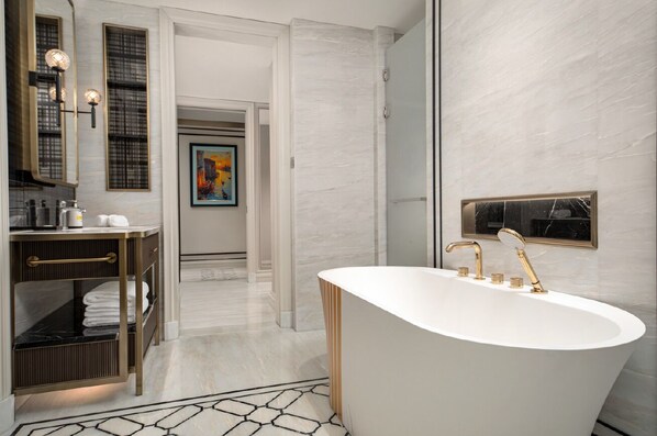 A modern bathroom with a freestanding bathtub, a vanity with a mirror, and a towel rack. - Pullman Beijing South - Newly Renovated (Beijing)