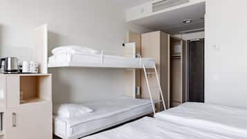 A bunk bed room with a desk, a coffee maker, and a wardrobe.