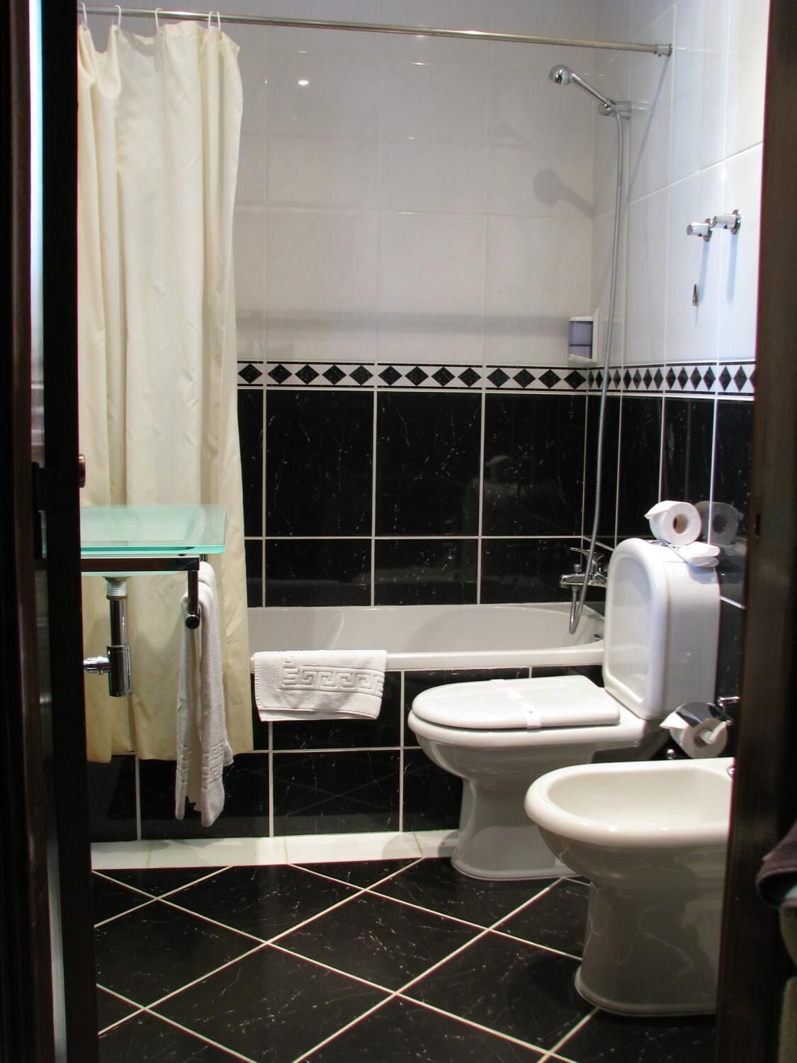 A bathroom with a bathtub, toilet, and shower.