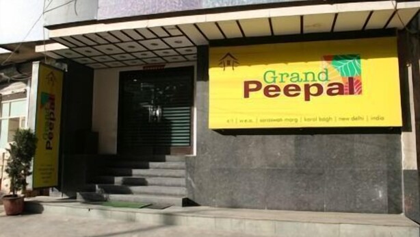 A building entrance with a sign reading "Grand PeePal" and a staircase leading to the entrance. - Hotel Grand Peepal (New Delhi)