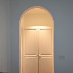 A closed double door with a white frame and a small light above it.