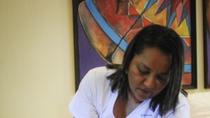 A massage therapy session with a person lying face down receiving back and shoulder massages. - Hotel Pasatiempo (Tamarindo)