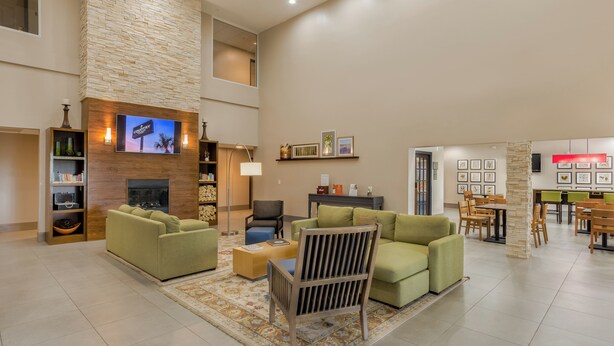 A spacious living area with a fireplace, comfortable seating, and a dining area.