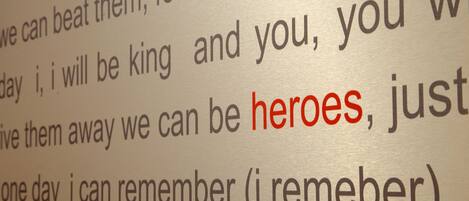 A close-up of a page with text, highlighting the word "heroes" in red.