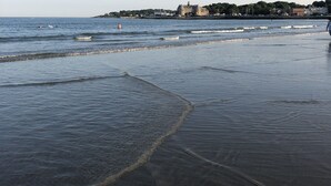 A beach with a castle in the background. - Atlantic House (Narragansett)