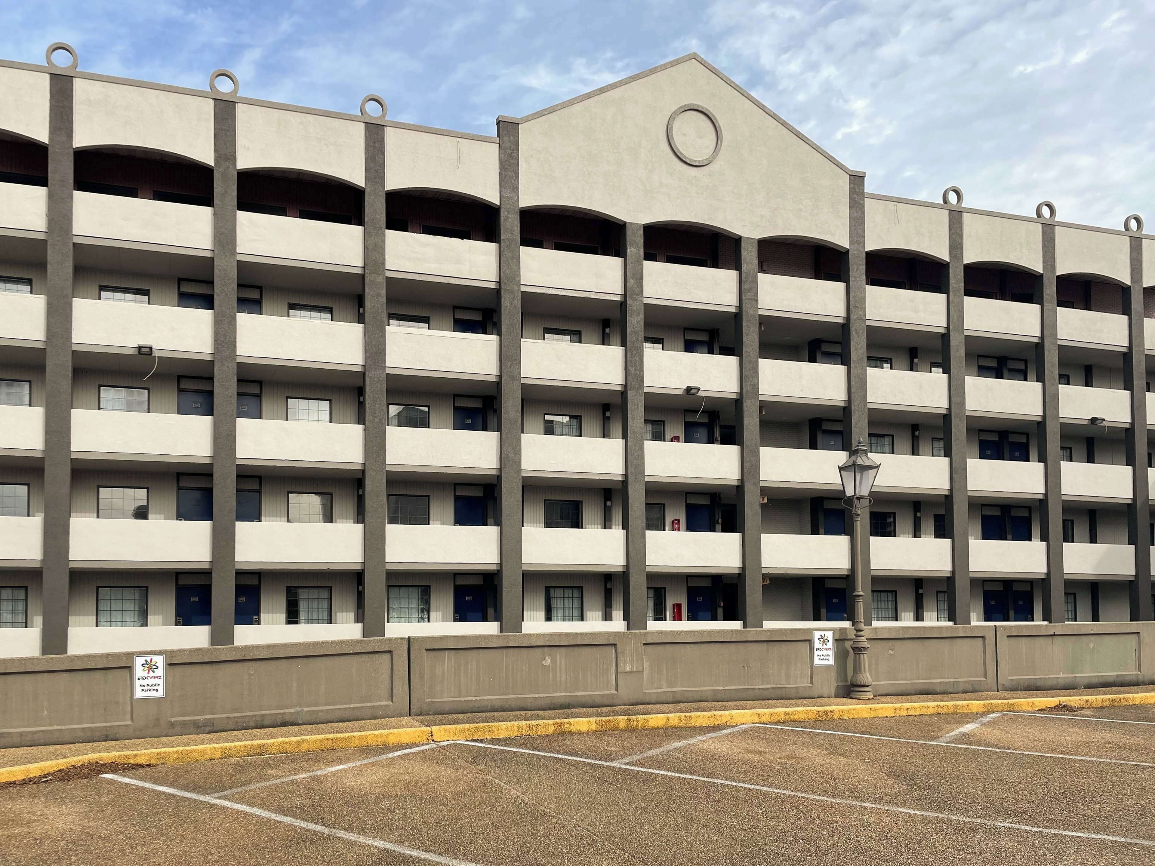 A multi-story parking garage with a flat roof and a central circular feature.