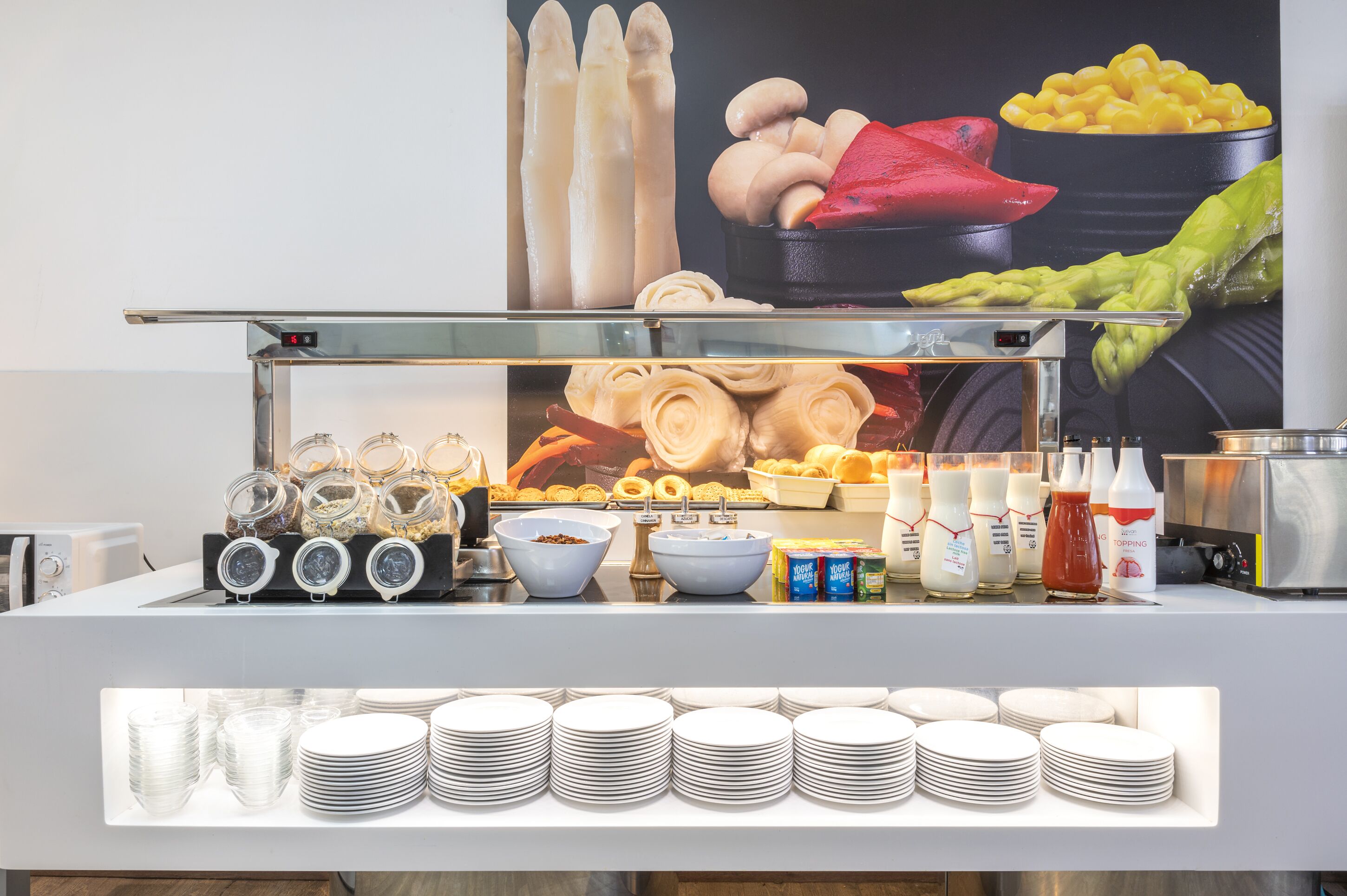 A buffet setup with various food items and condiments.